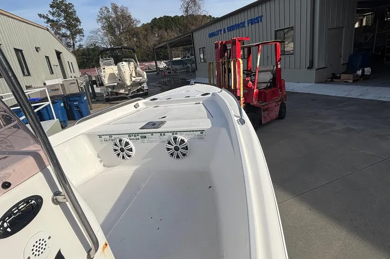 Slide: The Image of 2005 Sea Fox 160 Center Console boat at a service facility with forklift nearby. - 10