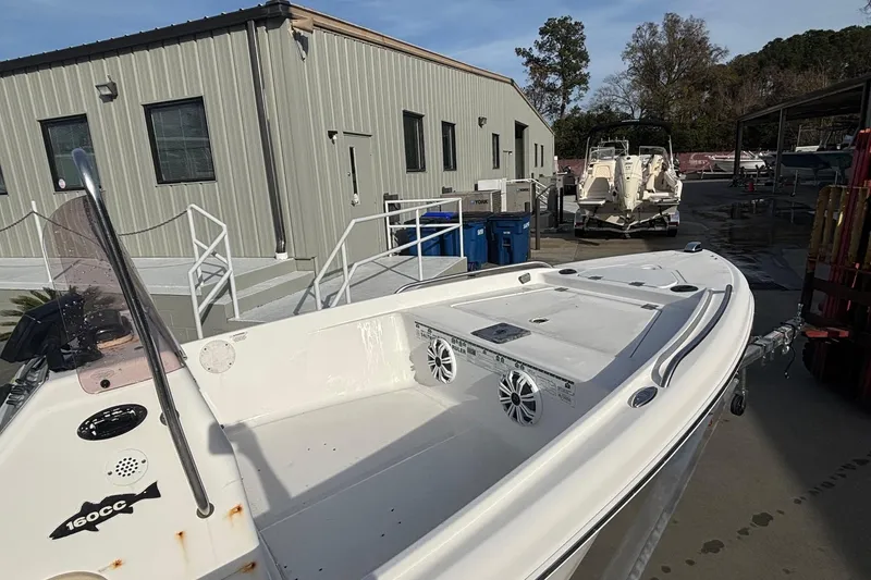 Slide: The Image of 2005 Sea Fox 160 Center Console boat docked near a building. - 9