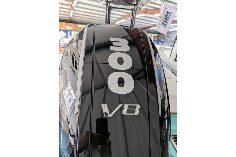 Slide: The Image of 2026 Caymas 26 HB with Mercury 300 V8 engine in showroom. - 12