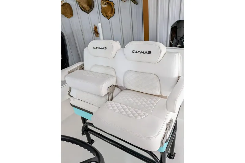Slide: The Image of Luxurious seating on 2026 Caymas 26 HB boat with white quilted upholstery. - 9
