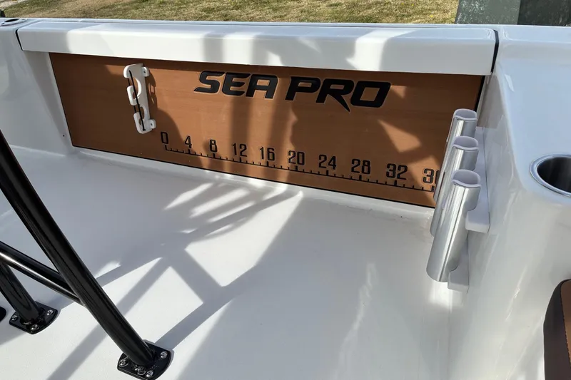 Slide: The Image of 2026 Sea Pro 250 Bay boat interior with measuring scale and rod holders. - 12