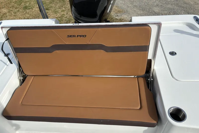 Slide: The Image of 2026 Sea Pro 250 Bay boat seat with brown upholstery and cup holder. - 13