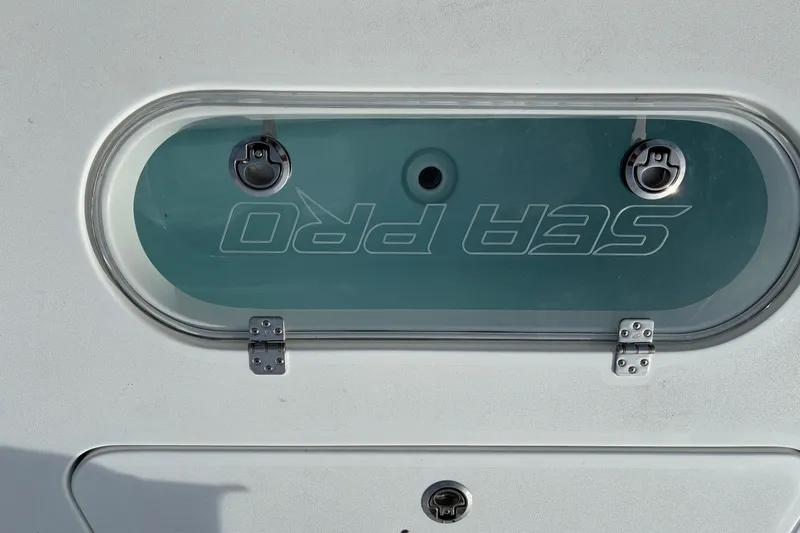 Slide: The Image of 2026 Sea Pro 250 Bay boat hatch with logo and secure latches. - 16