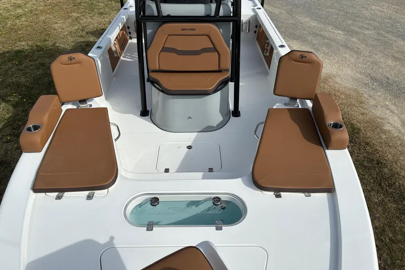 Slide: The Image of 2026 Sea Pro 250 Bay boat interior with tan seating and center console. - 4