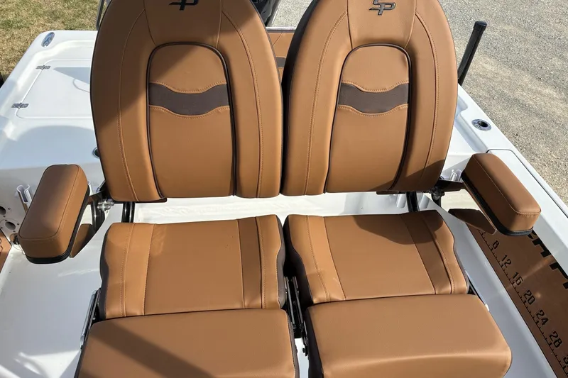 Slide: The Image of 2026 Sea Pro 250 Bay boat seats with brown leather upholstery and armrests. - 7