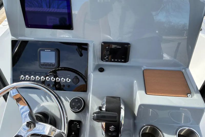 Slide: The Image of 2026 Sea Pro 250 Bay boat dashboard with steering wheel and control panel. - 8