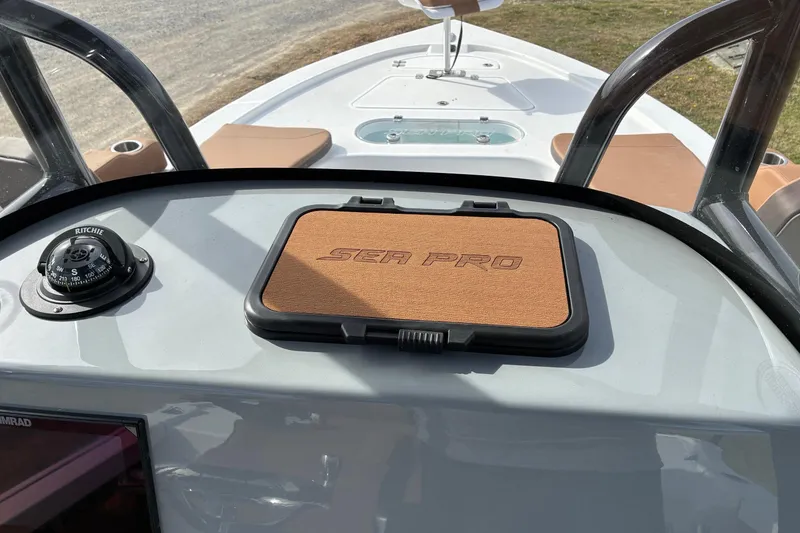 Slide: The Image of 2026 Sea Pro 250 Bay boat dashboard with compass and branded panel. - 9