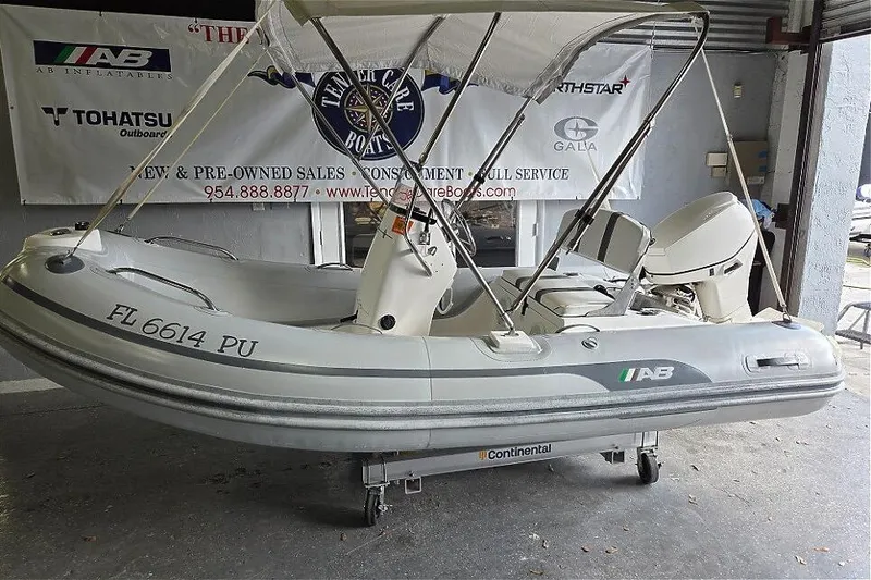 Slide: The Image of 2015 AB Inflatables Oceanus 12 VST boat interior with Evinrude 40HP engine, featuring sleek seating. - 4