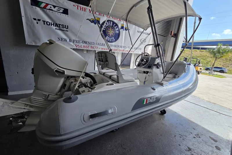 The Image of 2015 AB Inflatables Oceanus 12 VST with Evinrude 40HP engine, displayed indoors. - 0