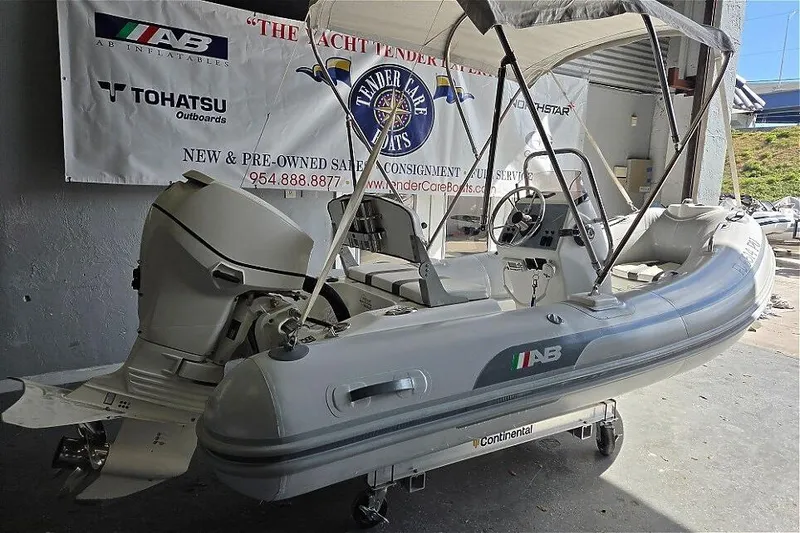 The Image of 2015 AB Inflatables Oceanus 12 VST with Evinrude 50HP engine, displayed indoors. - 1