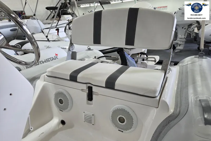 Slide: The Image of 2015 AB Inflatables Oceanus 12 VST boat interior with Evinrude 40HP, featuring cushioned seating. - 16