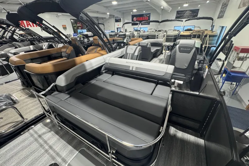Slide: The Image of 2026 Bennington 22 SSB Sport pontoon boat interior with luxurious seating in showroom. - 14