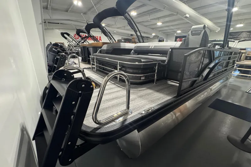 Slide: The Image of 2026 Bennington 22 SSB Sport pontoon boat in showroom, featuring sleek design and modern amenities. - 18