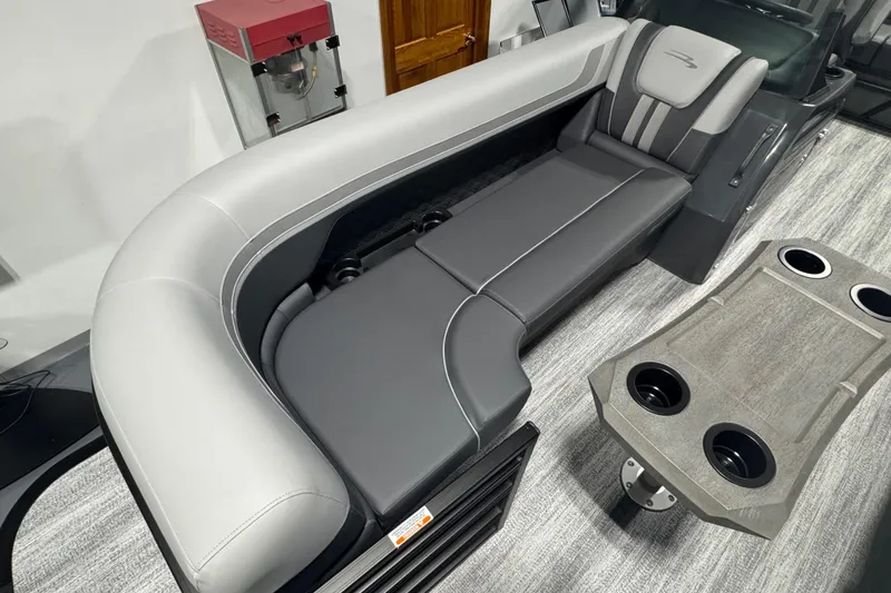 Slide: The Image of 2026 Bennington 22 SSB Sport boat interior with gray seating and table with cup holders. - 3