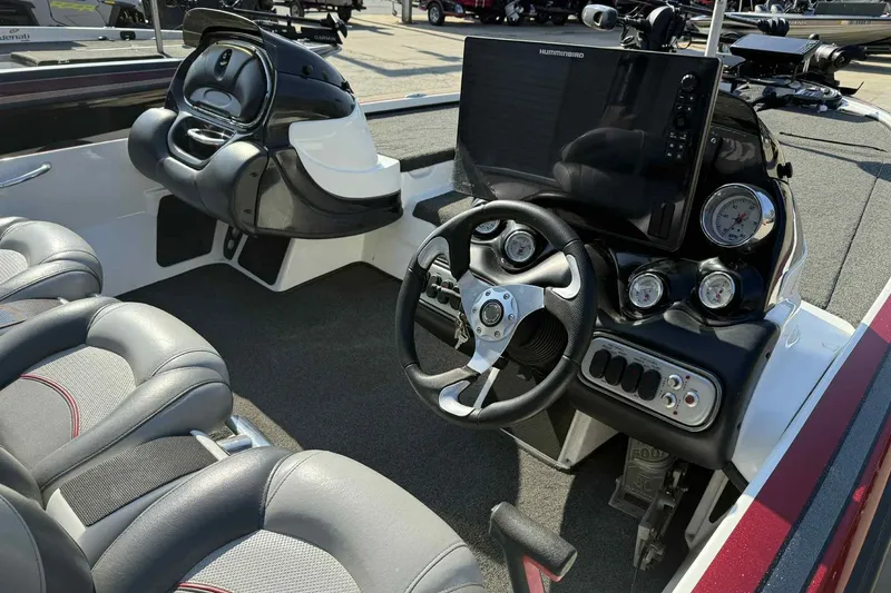 Slide: The Image of Interior of a 2014 Nitro Z-8 boat featuring steering wheel and control panel. - 4