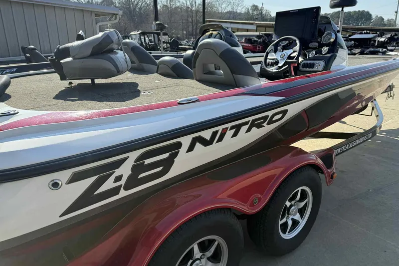 Slide: The Image of 2014 Nitro Z-8 boat with dual seats and steering console, parked outdoors. - 5