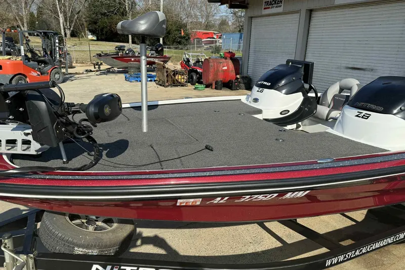 Slide: The Image of 2014 Nitro Z-8 boat with dual engines on a trailer, parked outdoors. - 7