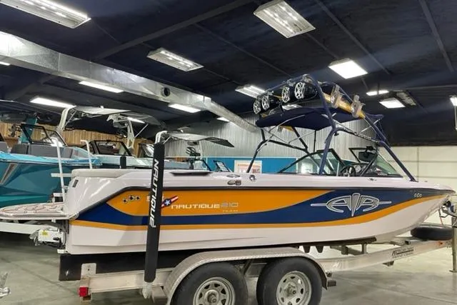 Slide: The Image of 2003 Nautique Super Air Nautique 210 boat on trailer in indoor showroom. - 10