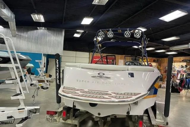 Slide: The Image of 2003 Nautique Super Air Nautique 210 boat in showroom, rear view with trailer. - 11