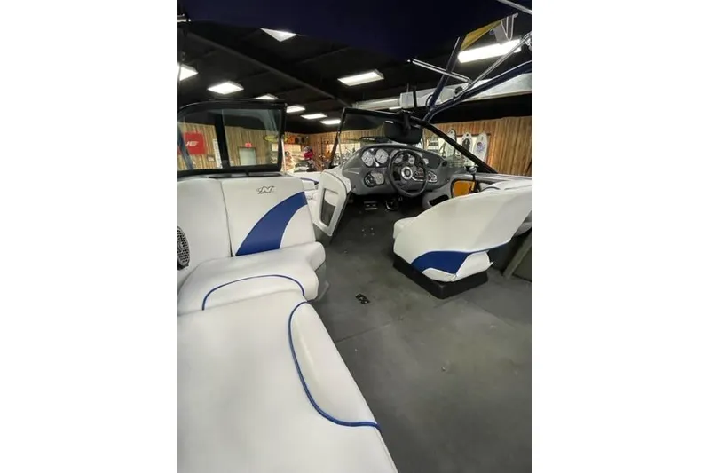 Slide: The Image of Interior of 2003 Nautique Super Air Nautique 210 boat with white and blue seating. - 12