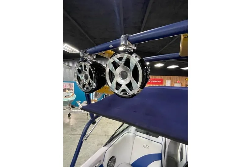 Slide: The Image of 2003 Nautique Super Air Nautique 210 with mounted speakers on a blue wakeboard tower. - 5