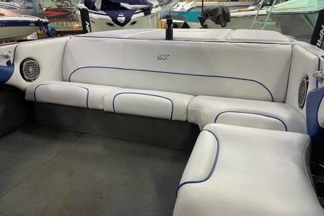 Slide: The Image of 2003 Nautique Super Air Nautique 210 interior with white seating and blue accents. - 6