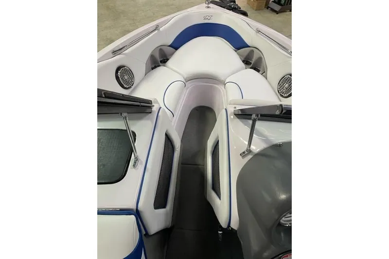 Slide: The Image of 2003 Nautique Super Air Nautique 210 boat interior with white and blue seating. - 8