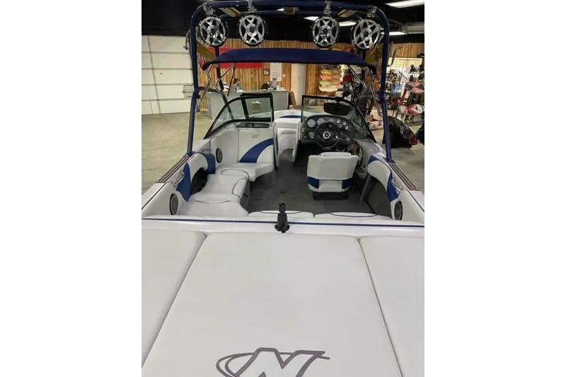 Slide: The Image of 2003 Nautique Super Air Nautique 210 boat interior with speakers and seating. - 9
