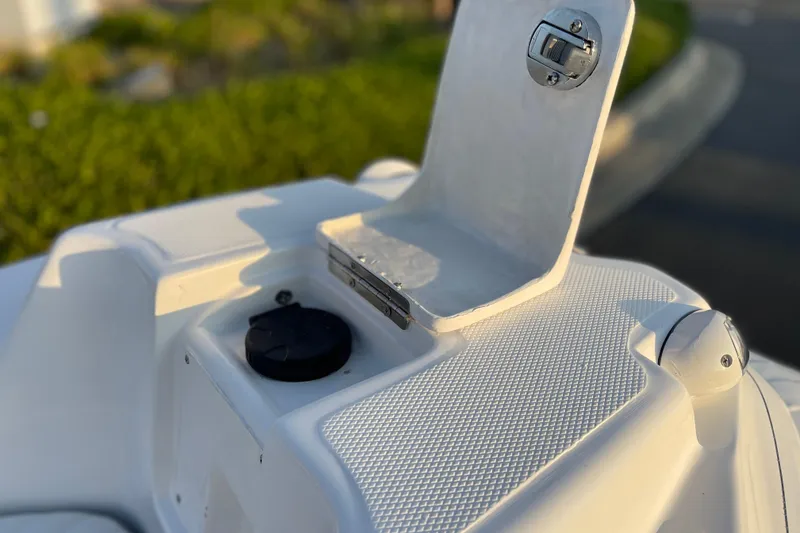 Slide: The Image of Close-up of 2026 Caribe DL12 boat's storage compartment and latch. - 11