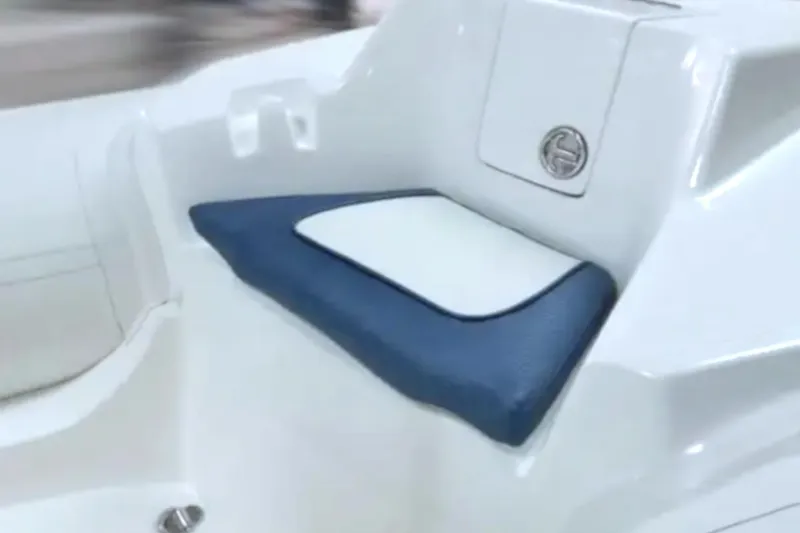 Slide: The Image of 2026 Caribe DL12 boat seat with blue and white cushion detail. - 2