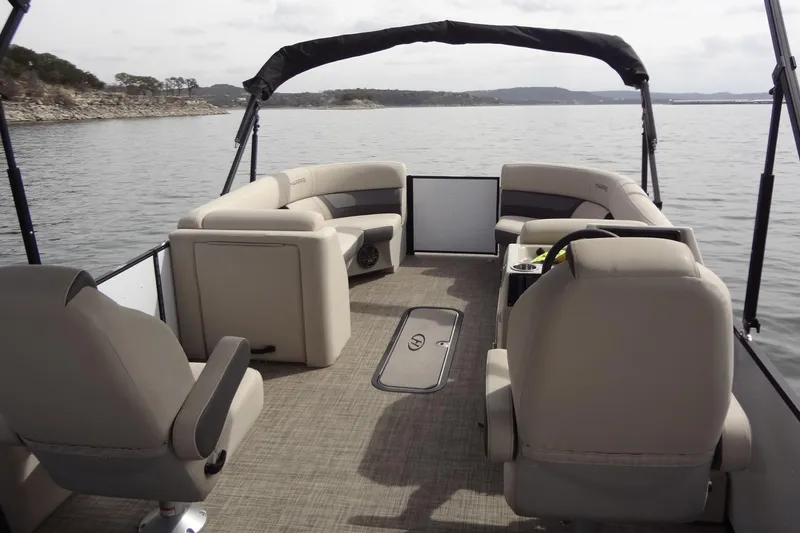 Slide: The Image of 2022 Harris FloteBote 230 Cruiser pontoon boat interior on a calm lake. - 12