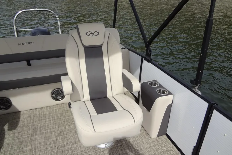 Slide: The Image of 2022 Harris FloteBote 230 Cruiser interior with captain's chair and cup holders. - 17