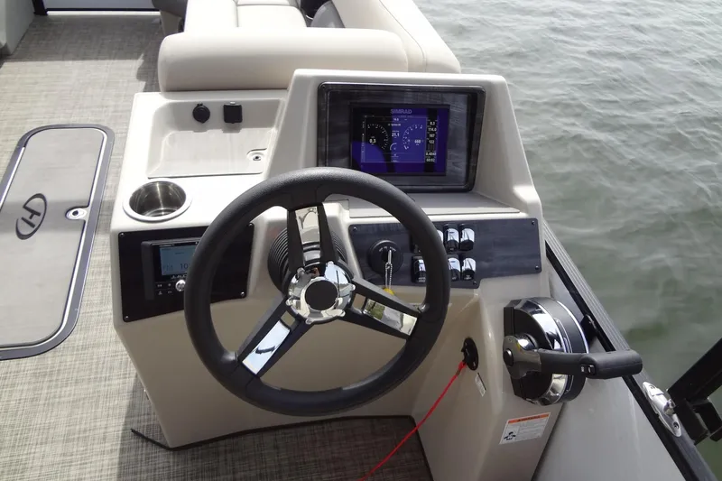 Slide: The Image of Steering console of 2022 Harris FloteBote 230 Cruiser pontoon boat on water. - 19