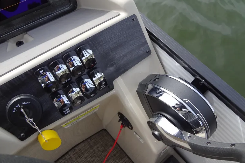 Slide: The Image of Control panel of 2022 Harris FloteBote 230 Cruiser with steering and switches. - 22