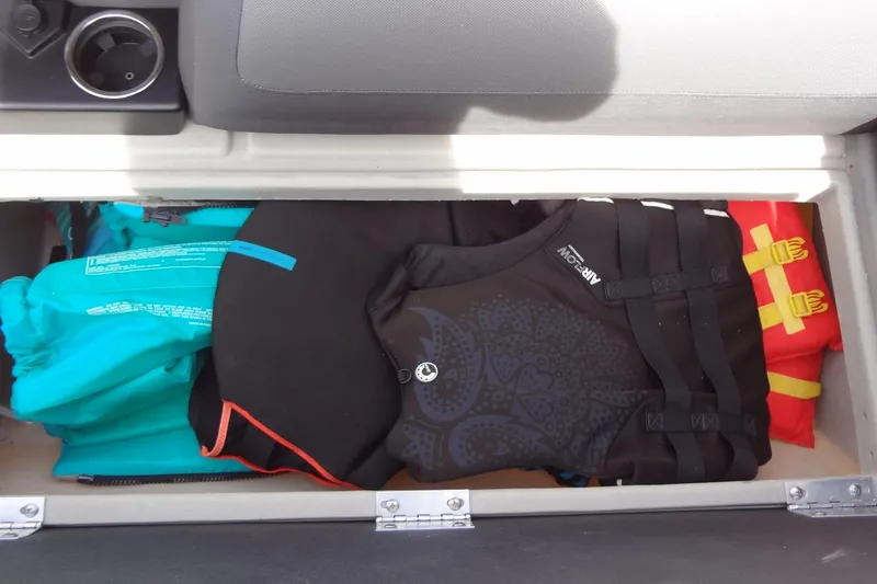 Slide: The Image of Storage compartment in 2022 Harris FloteBote 230 Cruiser with life jackets and gear. - 37