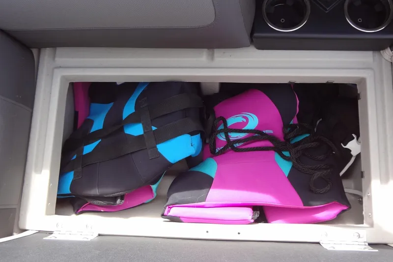 Slide: The Image of Storage compartment in 2022 Harris FloteBote 230 Cruiser with colorful life jackets. - 38