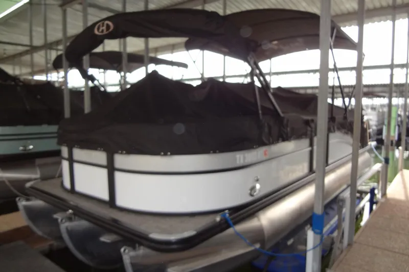 Slide: The Image of 2022 Harris FloteBote 230 Cruiser pontoon boat in covered dock. - 41