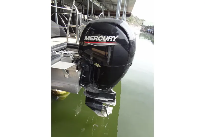 Slide: The Image of Outboard motor on 2022 Harris FloteBote 230 Cruiser, docked on calm water. - 47