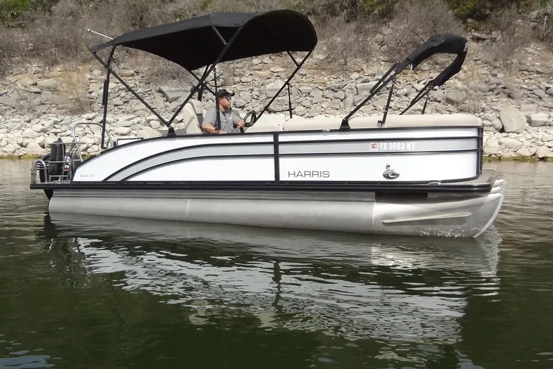 Slide: The Image of 2022 Harris FloteBote 230 Cruiser pontoon boat on calm water, side view. - 5