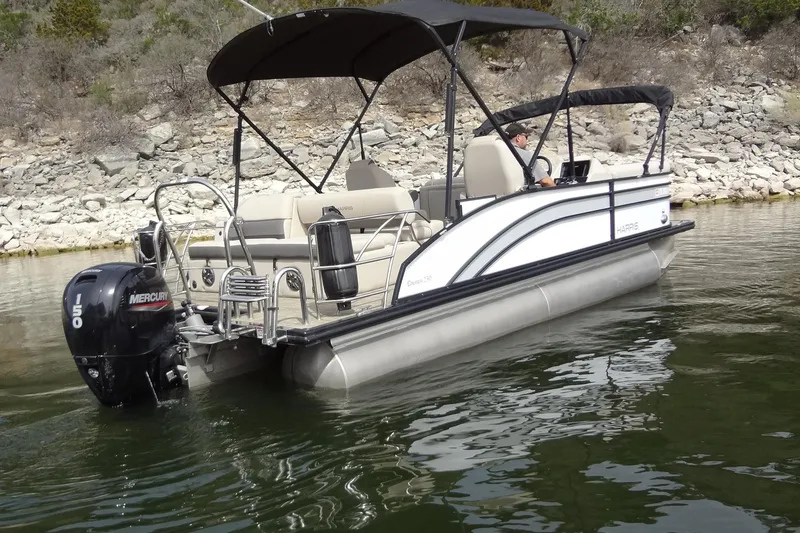 Slide: The Image of 2022 Harris FloteBote 230 Cruiser pontoon boat on a calm lake. - 7