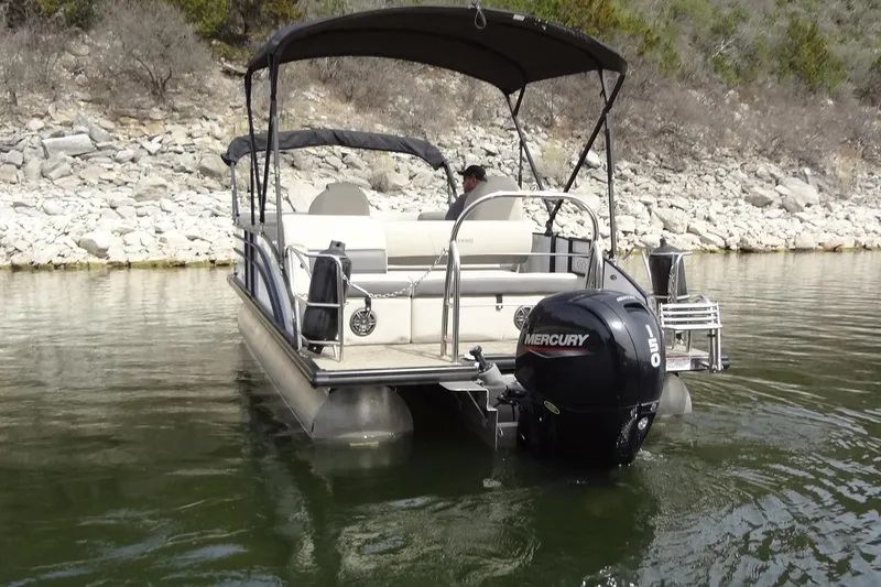 Slide: The Image of 2022 Harris FloteBote 230 Cruiser pontoon boat on a calm lake with Mercury engine. - 9