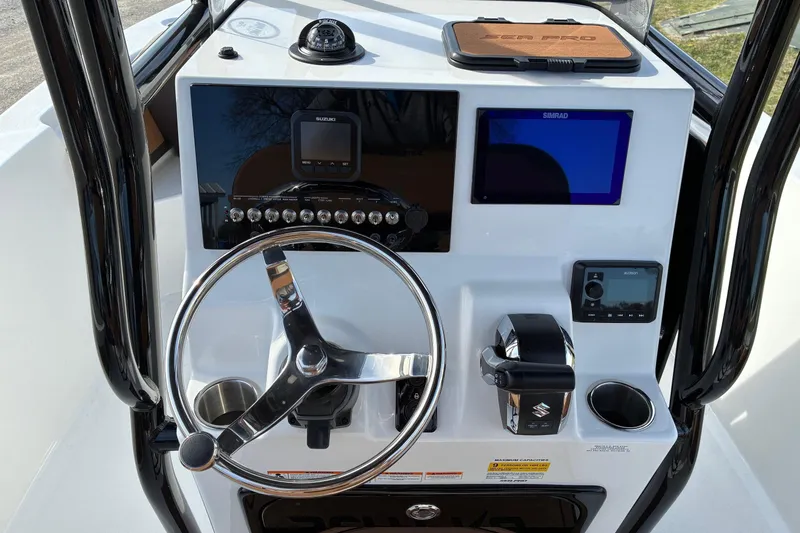 Slide: The Image of 2026 Sea Pro 225FLX Sandbar boat dashboard with steering wheel and navigation controls. - 11