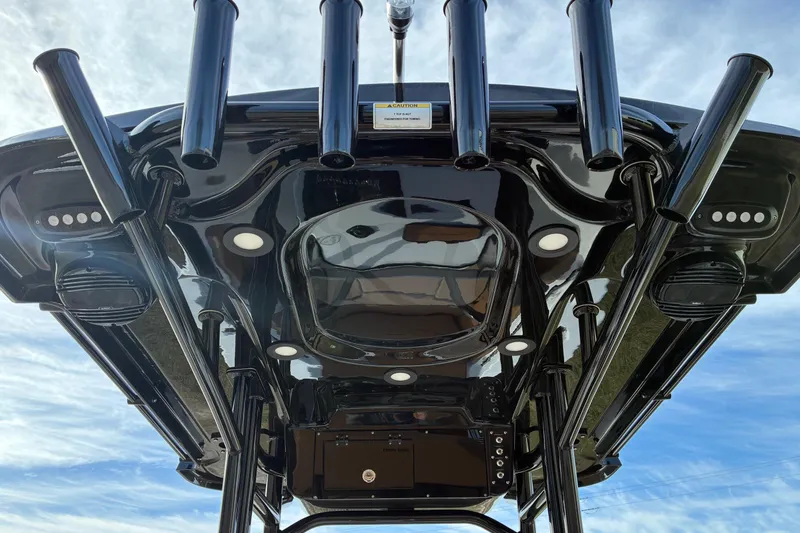 Slide: The Image of 2026 Sea Pro 225FLX Sandbar boat, sleek black design, rod holders, and modern features. - 13