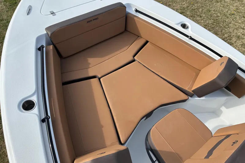 Slide: The Image of 2026 Sea Pro 225FLX Sandbar boat interior with tan cushioned seating. - 15