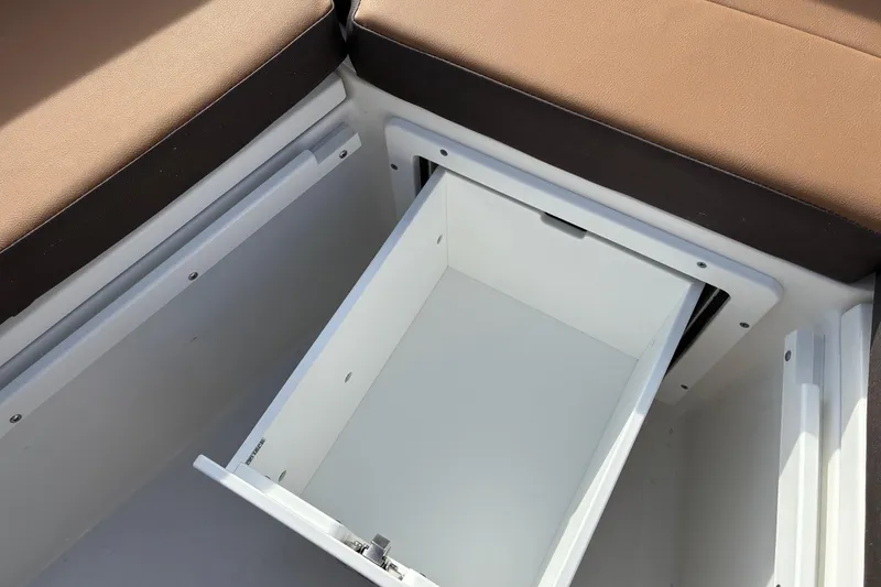 Slide: The Image of 2026 Sea Pro 225FLX Sandbar boat storage compartment with cushioned seating. - 18
