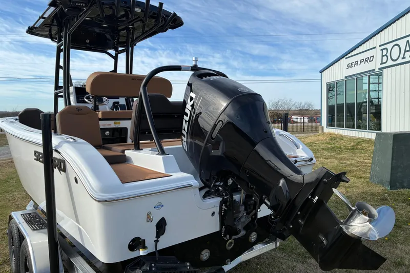 Slide: The Image of 2026 Sea Pro 225FLX Sandbar boat with Suzuki outboard motor, parked near dealership. - 4