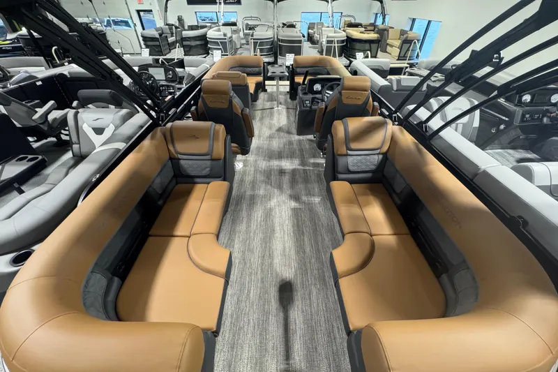 Slide: The Image of 2026 Bennington 22 SSR Luxe pontoon boat interior with luxurious tan seating and modern design. - 14