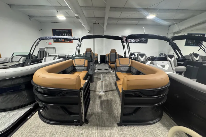 Slide: The Image of 2026 Bennington 22 SSR Luxe pontoon boat with luxurious seating in showroom. - 2