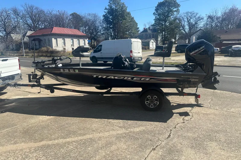 The Image of 2024 Tracker Pro Team 175 TXW boat on trailer, parked outdoors. - 0