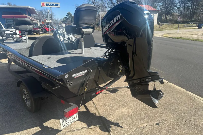 Slide: The Image of 2024 Tracker Pro Team 175 TXW boat with Mercury engine, parked outdoors. - 11